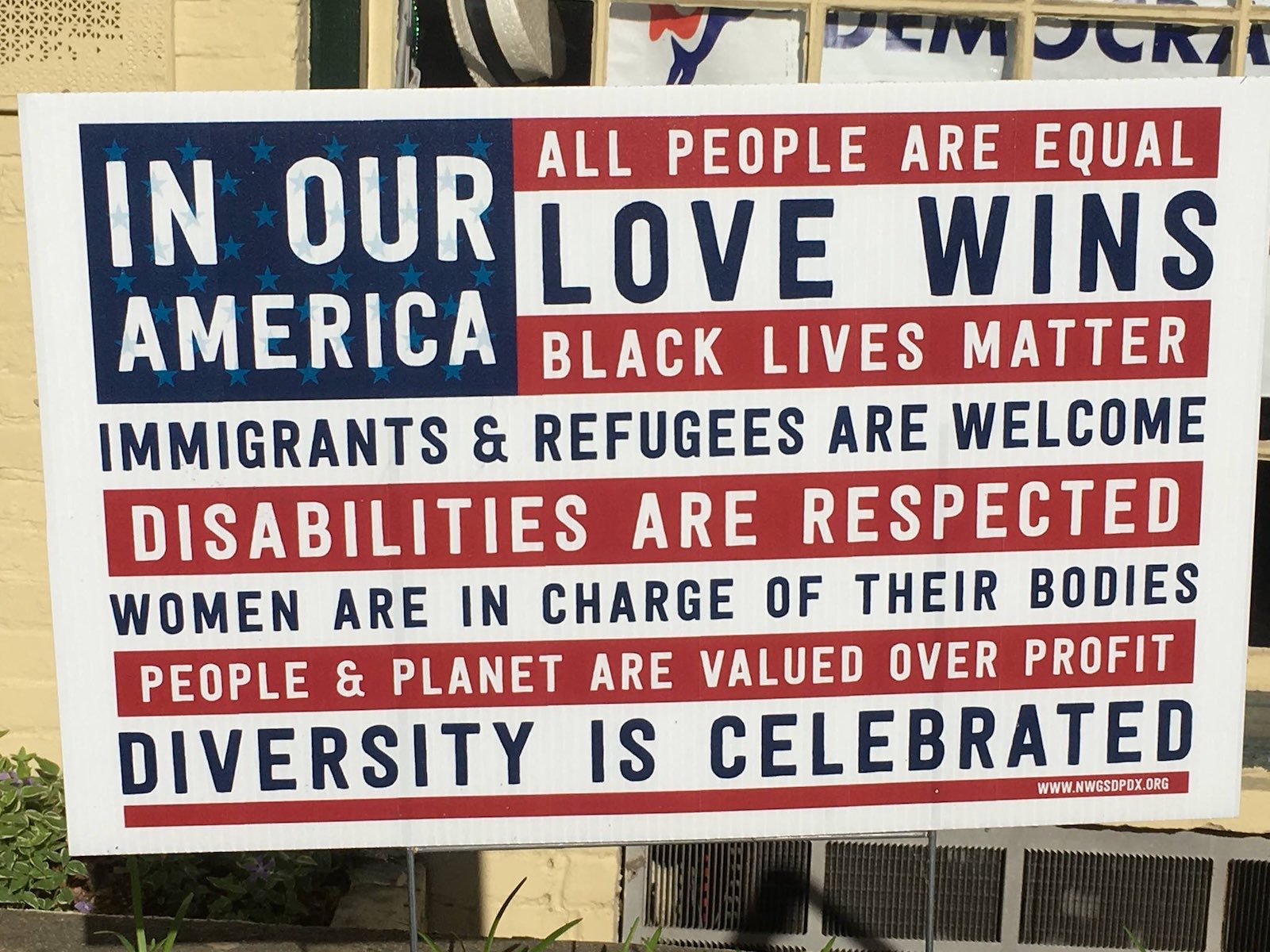 A sign reading: In our America, all people are welcome, love wins, diversity is celebrated