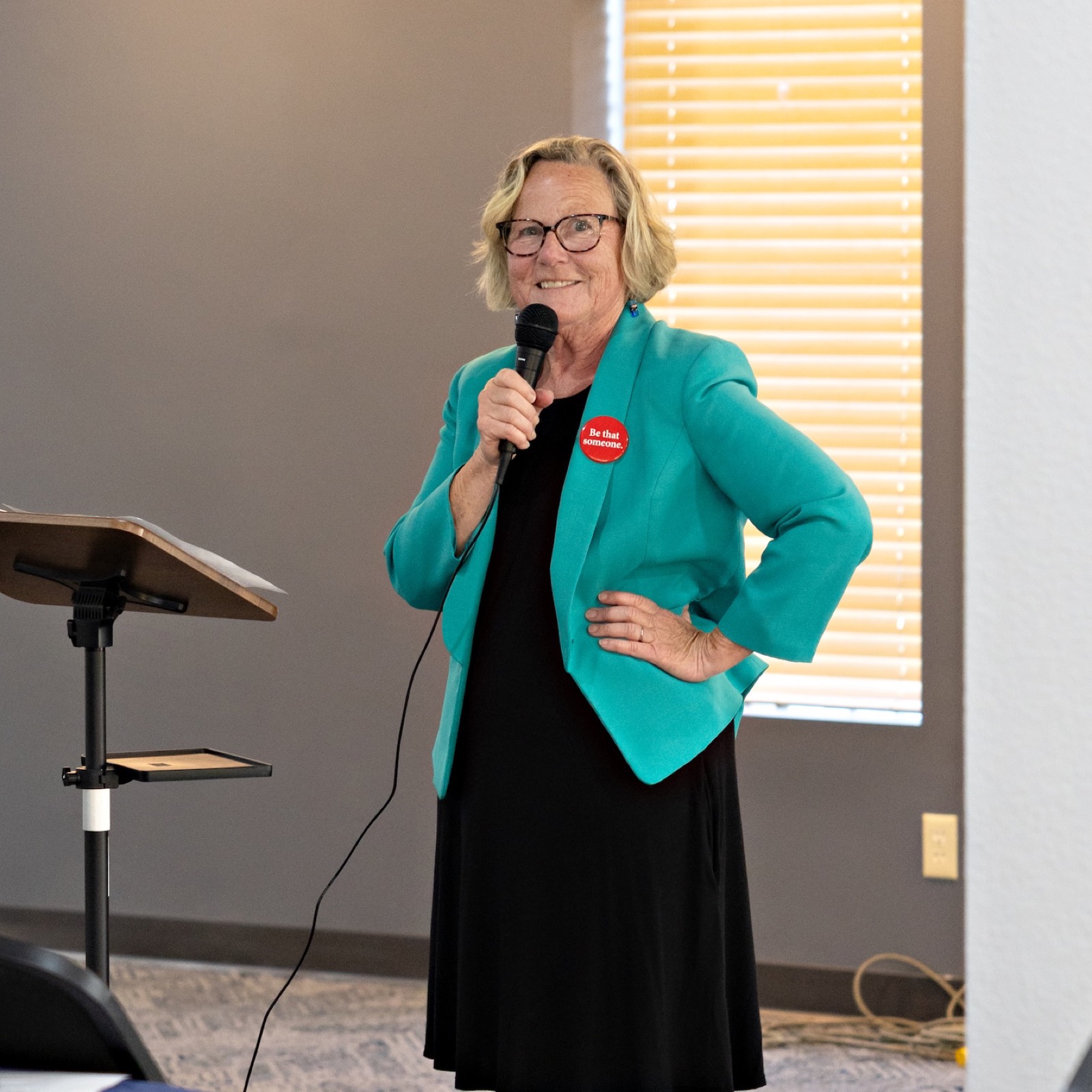 A speaker addresses the room from the microphone