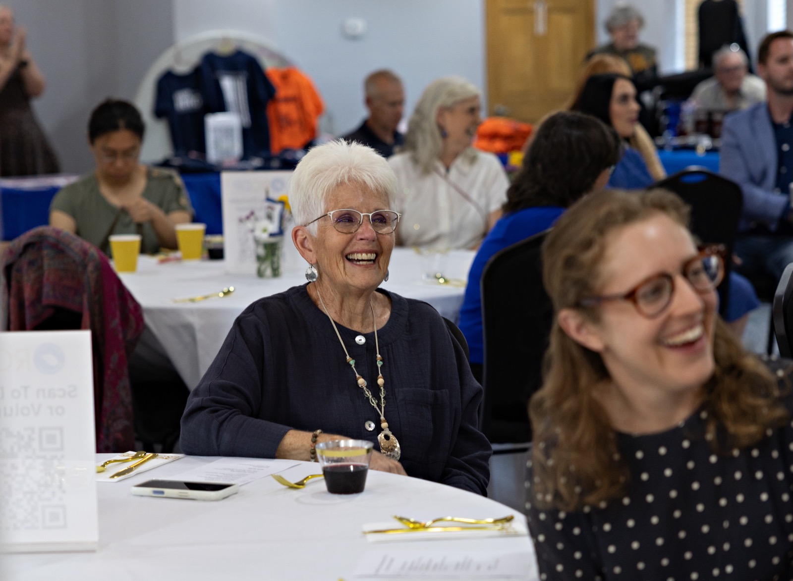 Guests smiling around a banquet table