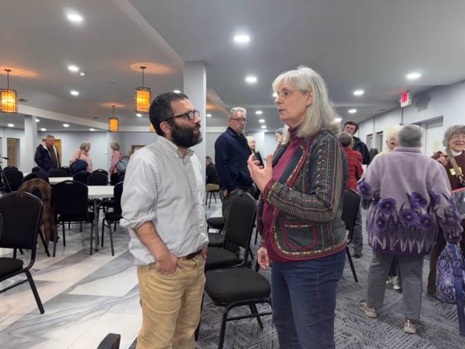 Ace Parsi talking one-on-one with a voter
