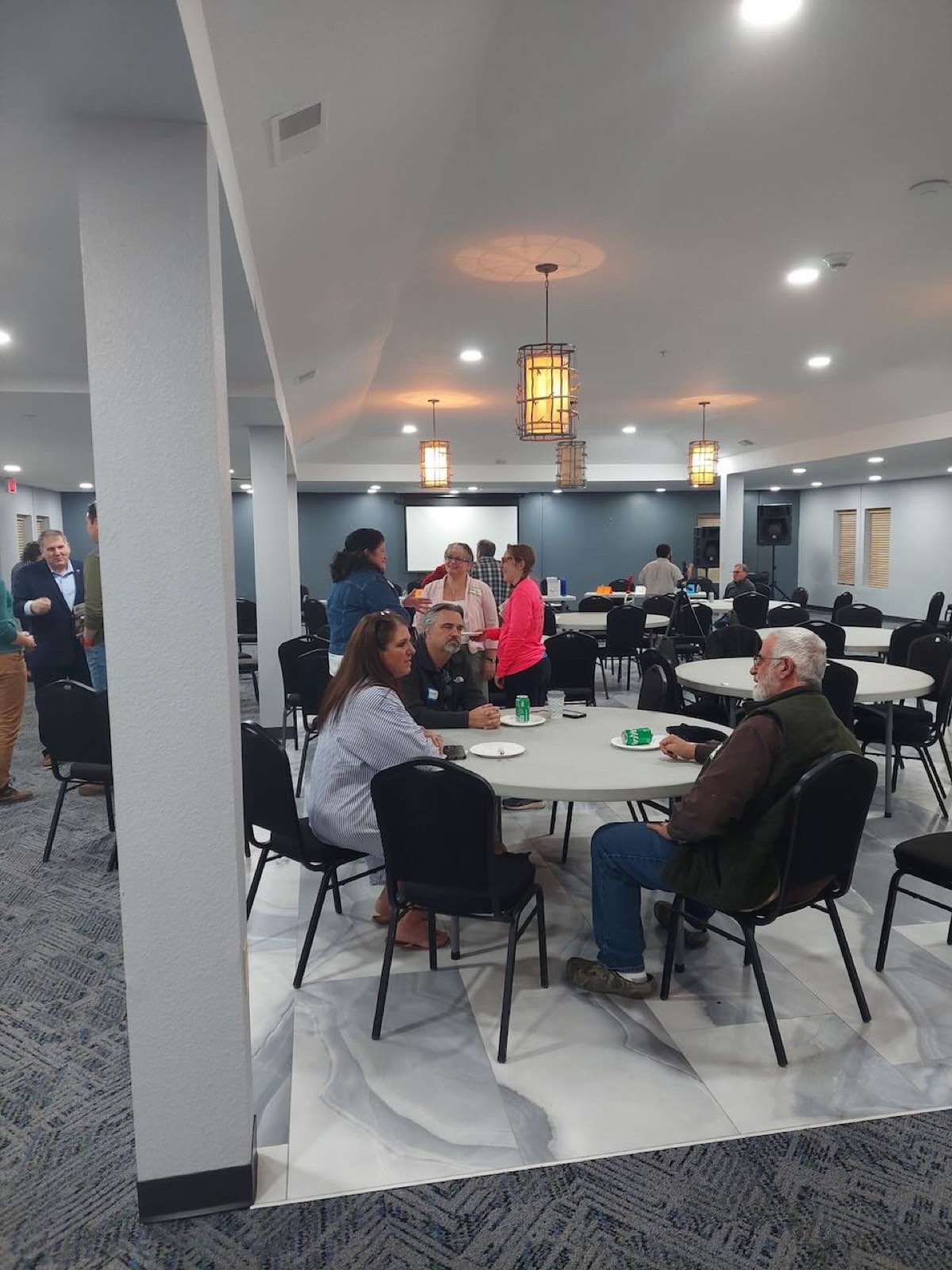 A room full of members seated at tables