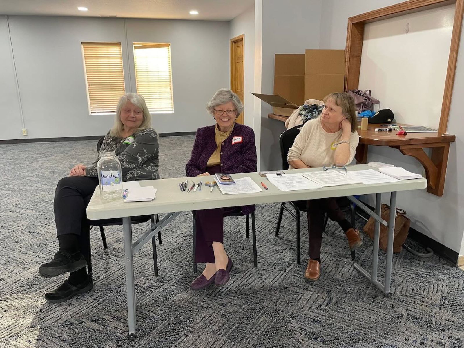 Volunteers greeting guests at the welcome table