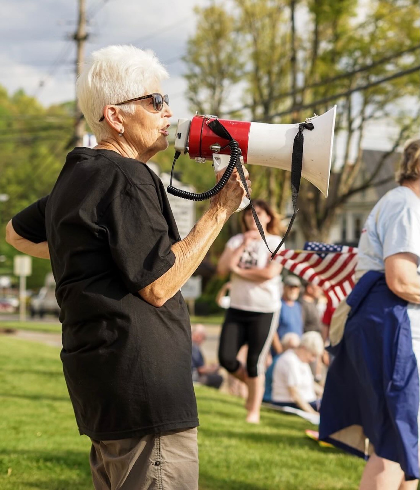 A demonstrator addresses the crowd with a megaphone
