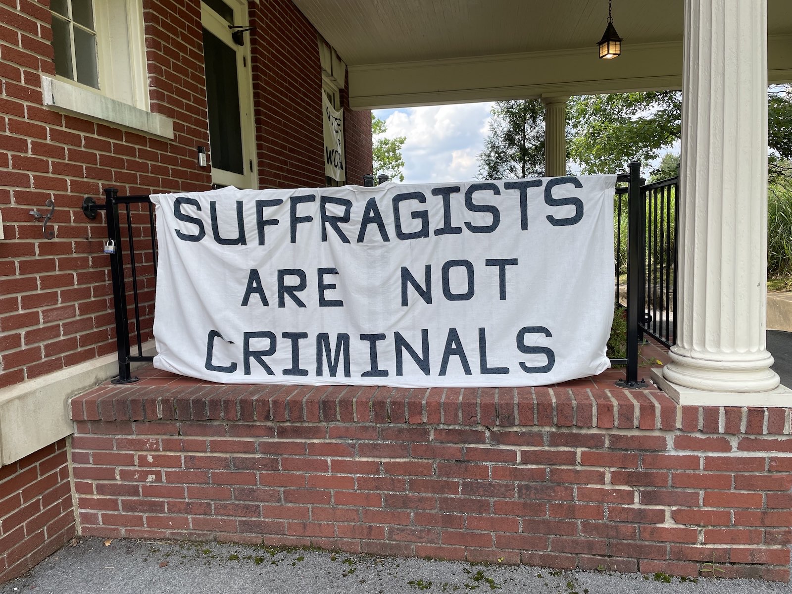 A banner reading 'Suffragists are not criminals'